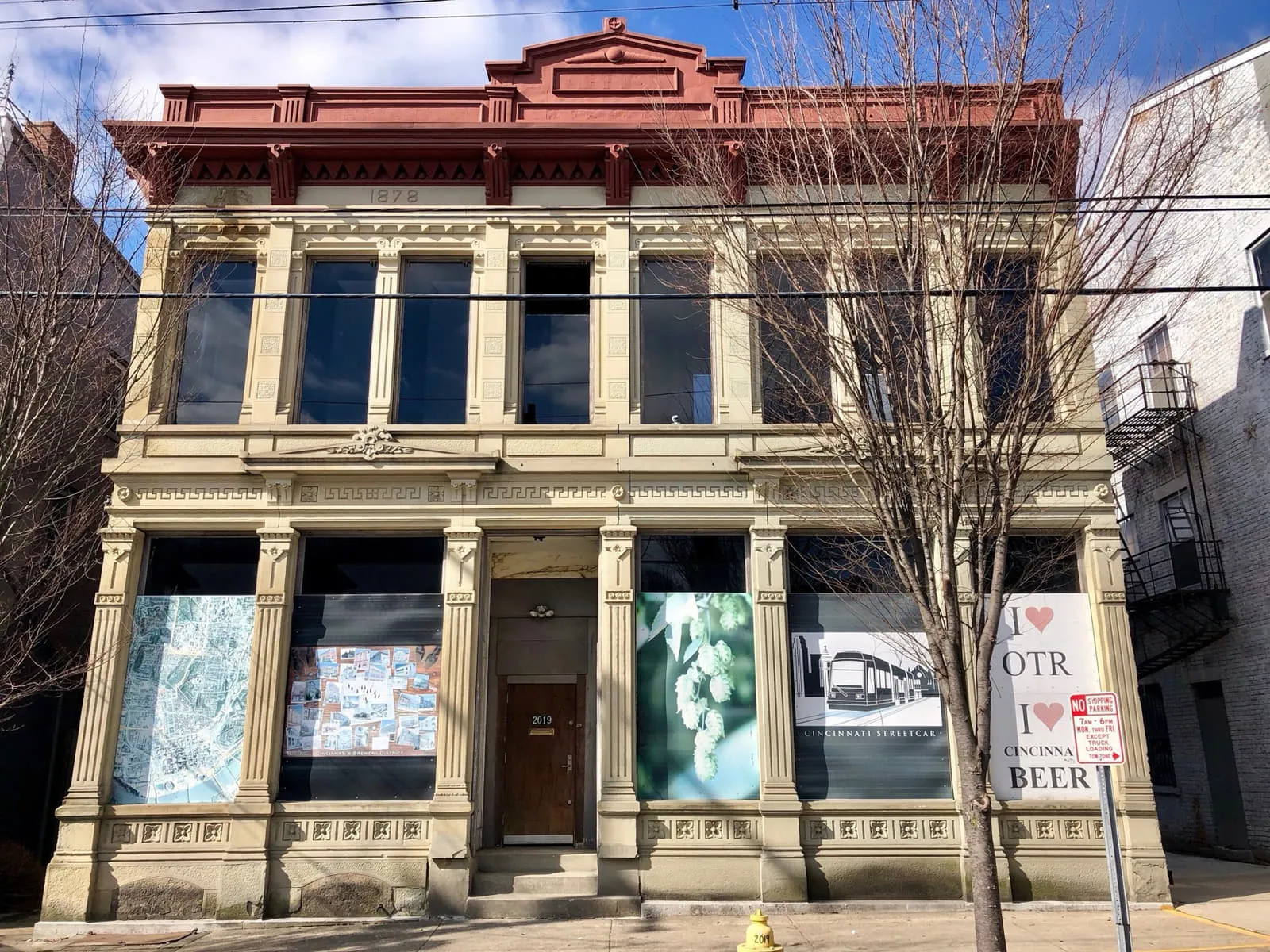 An ornate Italianate commercial building on Elm Street in Over-the-Rhine, Cincinnati, with the date 1878 carved into its cornice.